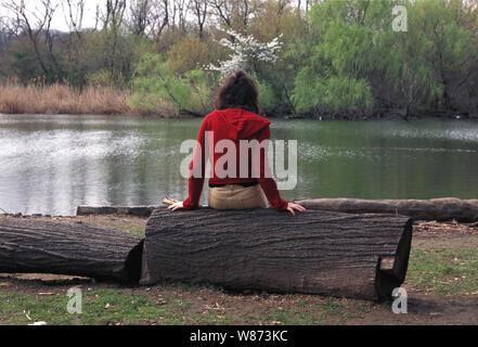 Junges Mädchen versucht, Sachen herauszufinden, in Prospect Park, Brooklyn, New York Herr gedrückt Stockfoto