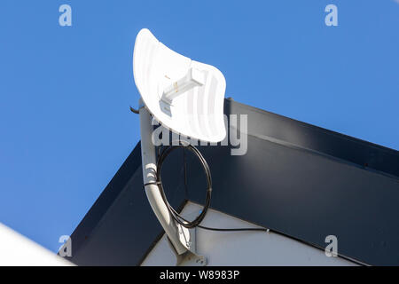 Kleiner Funkempfänger für Haushalt ADSL-Internetzugang in Zusammenhang mit einem Booster und Router auf der Außenwand eines Hauses montiert Stockfoto