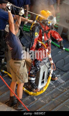 Marine Taucher zugeordnet Mobile Tauchen und Bergung Einheit 2 mit einem Hochdruckreiniger zu reinigen und zu desinfizieren ein Taucher sofort, nachdem er abgeschlossen Tauchbasen in New Orleans, La., Sept. 11, 2005. Die Taucher Arbeiten von der gut Deck des Dock Landung Schiff USS Tortuga (LSD 46), am Naval Support Activity New Orleans vertäut. Departement für Verteidigung Einheiten werden als Teil der Gemeinsamen Task Force Katrina mobilisiert Katastrophenhilfe der Federal Emergency Management Agency in der Gulf Coast Bereiche, die durch Hurrikan Katrina verwüstet zu unterstützen. Stockfoto