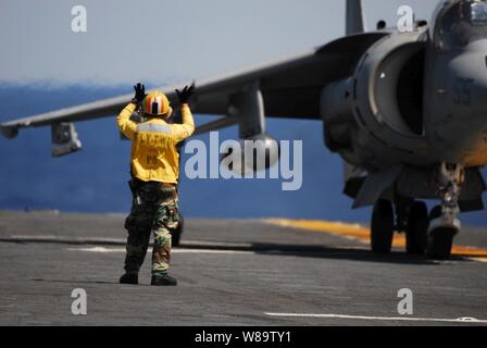 U.S. Navy Petty Officer 2nd class Charles Imanil leitet ein AV-8B Harrier II Flugzeuge auf dem Flugdeck des Amphibious Assault ship USS Kearsarge (LHD 3) Am 19. Mai 2007. Die kearsarge und schiffte sich Marine Medium Helicopter Squadron 261 beteiligen sich an einer Einheit Training in den Atlantischen Ozean. Imanil ist ein U.S. Navy Aviation Boatswainís Mate Handling. Stockfoto