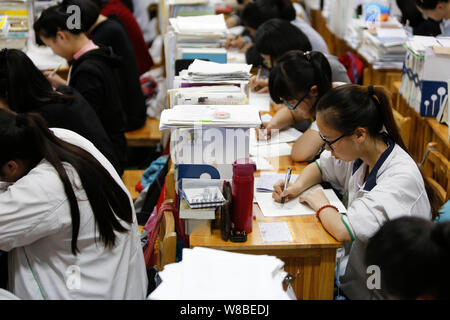 Chinesische Studenten überprüfung Lehrbücher in Vorbereitung auf die anstehenden nationalen Hochschuleingang Prüfung, auch als gaokao bekannt, in ihrem Klassenzimmer an der Gany Stockfoto