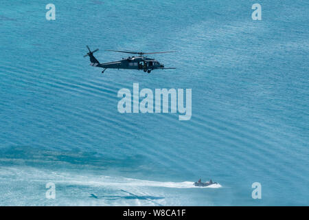 Ein HH-60G Pave Hawk vom 33. Rescue Squadron, senkt eine pararescuemen in ein Schiff im Meer während einer Operation, 26. Juli 2019, aus der Kadena Air Base, Japan. Mitglieder des 33. und 31. Rescue Staffeln von Kadena AB Bahnhof und arbeiten zusammen, um Unterstützung für den Kampf zur Rettung und Katastrophenhilfe zur Verfügung zu stellen. (U.S. Air Force Foto von Airman 1st Class Matthew Seefeldt) Stockfoto