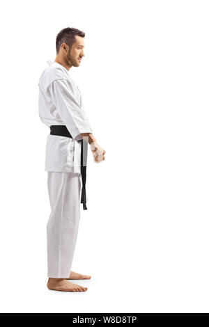 Volle Länge Profil Schoß eines Mannes im Karate Kimono mit Gürtel Schwarz auf weißem Hintergrund Stockfoto
