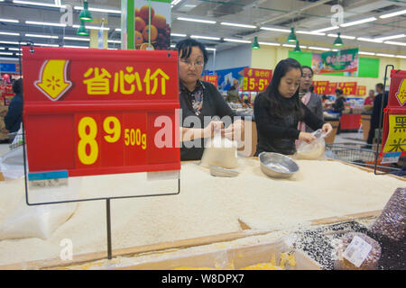 ------ Chinesische Kunden kaufen Reis in einem Supermarkt in der Stadt Changchun im Nordosten Chinas in der Provinz Jilin, 7. Dezember 2014. Guangdong ist die Intensivierung der f Stockfoto