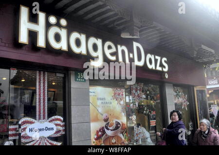 ---- Fußgänger vorbei ein Häagen-dazs Ice Cream Shop in Shanghai, China, 21. Dezember 2013. American ice cream Marke Häagen-Dazs will ge Stockfoto