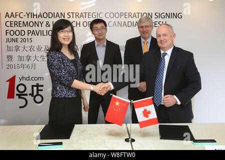 Barry Zhu Pengcheng, hinten links, Chief Merchandising Officer von Yihaodian.com, und der kanadische Botschafter in China Kerl Saint-Jacques, hinten rechts, t teilnehmen Stockfoto