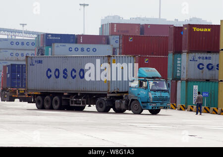 ---- Ein Lkw mit einem Container der Cosco Pässe geladen durch Stapeln der Container im Hafen der Stadt Rizhao Rizhao in der ostchinesischen Provinz Shandong, Stockfoto