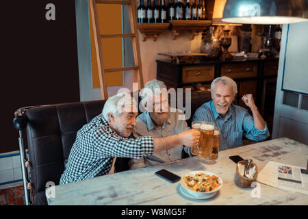 Rentner feiern den Sieg der favorisierten Fußballmannschaft Stockfoto
