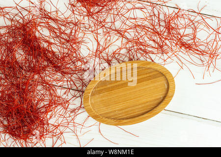 Menge ganzes red chili Threads auf Bambus Platte flatlay auf weißem Holz Stockfoto