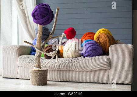 Warme Innenausstattung mit Merinowolle Kugeln in Grün auf Weiß Sofa und auf dekorative Baum, Wohnzimmer in hellen Farben Stockfoto