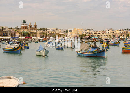 Marsaxlokk, Malta: 16. Mai 2019: Traditionell gemusterte bunte Boote Luzzu im Hafen von mediterranen Fischerdorf Marsaxlokk, Malta Stockfoto