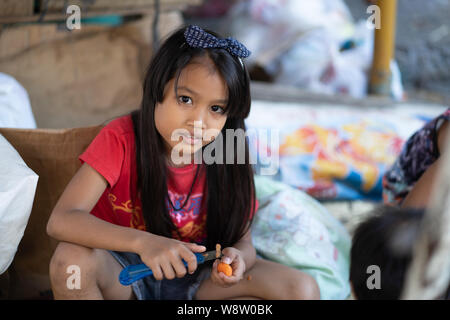 Portrait einer jungen philippinischen Mädchen während Ihrer Familie helfen, auf einem Marktstand, Cebu City, Philippinen Stockfoto