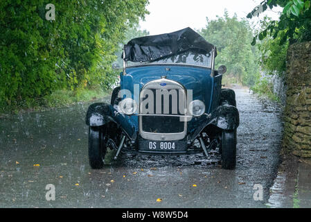 1929 Ford Roadster Fahrer bei schwerem Regen gefangen, Frome, Somerset UK Stockfoto