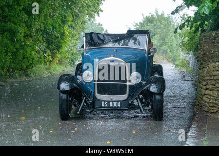 1929 Ford Roadster Fahrer bei schwerem Regen gefangen, Frome, Somerset UK Stockfoto