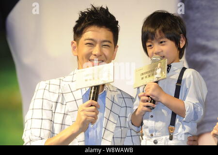 Taiwanesische Sänger und Schauspieler Jimmy Lin, Links, und sein Sohn Kimi Lächeln während einer Pressekonferenz für Jimmys Autobiografie in Peking, China, 27. Juni 2014. Stockfoto