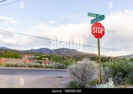 Stop-Schild am Schnittpunkt von Encantado fahren und Bischöfe Lodge Road in Santa Fe, New Mexico am Abend Sonnenuntergang und Berge Stockfoto