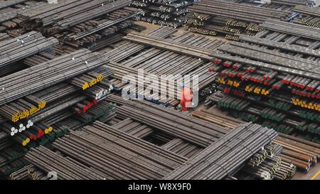 ---- Ein chinesischer Arbeiter untersucht einen Stapel von Stahl im Ausland in einem Werk von dongbei Special Steel Group in Dalian geliefert werden, im Nordosten Kinne Liao Stockfoto