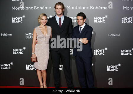Australische Schauspieler Chris Hemsworth, Mitte und seine spanische Schauspielerin Frau Elsa Pataky, Links, Pose mit einer Führungskraft auf dem roten Teppich, wie sie für Ankommen Stockfoto