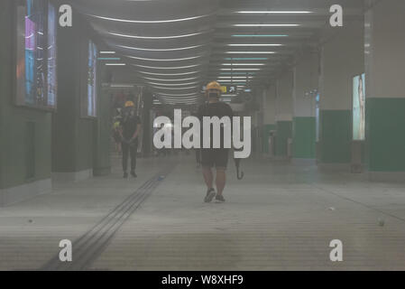 Die Demonstranten gehen Sie durch die MTR-Station mit Tränengas gefüllt. Tausende von Anti-Elab die Demonstranten auf das Polizeipräsidium in ihrem Kampf gegen die Regierung von Hongkong marschierten. Die Demonstranten mit der Polizei in verschiedenen Bezirken zusammengestoßen, die zu Dutzenden von Gas Umläufe und Massenverhaftungen reißen. Unter vielen anderen Forderungen, die Demonstranten wollen die vollständige Rücknahme der umstrittenen Auslieferung Rechnung. Stockfoto