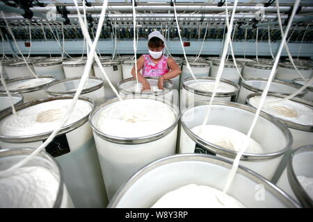 ---- Eine weibliche chinesischer Arbeiter übernimmt Produktion von Garn nach Südkorea bei einer Textilfabrik in Stadt Huaibei, die exportiert werden sollen, East China Anhui provi Stockfoto