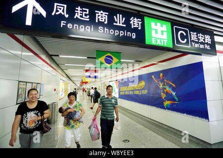 Passagiere unter nationalen Flaggen der Länder, die an der FIFA WM 2014 in einer U-Bahn-Station in Hangzhou City, East China Zhejian Stockfoto