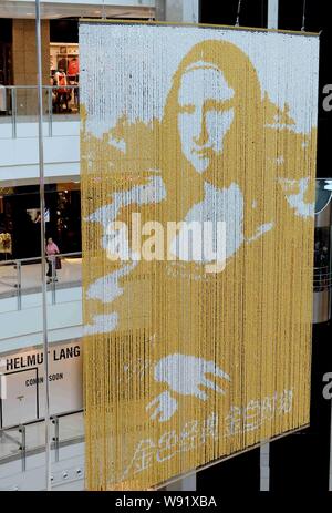 Eine goldene Porträt der Mona Lisa, die aus mehr als 100.000 Ferrero Rocher Schokolade Kugeln ist im Grand Gateway Shopping Mall in Shanghai, China, hing. Stockfoto