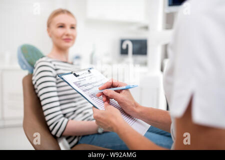 Zahnarzt schriftlich Verordnungen für Ihre neuen Patienten. Stockfoto