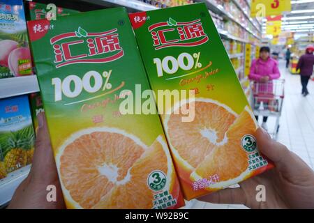 ---- Ein chinesischer Kunde wählt Kartons von Huiyuan juice in einem Supermarkt im Osten Nantong, China Jiangsu Provinz, 24. März 2013. Hongkong - Liste Stockfoto