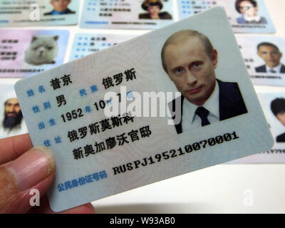 Ein Mann zeigt eine gefälschte Chinesischen ID-Karte des russischen Präsidenten Wladimir Putin zum Verkauf an einen Stand auf einer Straße in Guangzhou City, South China Guangdong provi Stockfoto