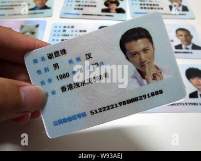 Ein Mann zeigt eine gefälschte Chinesischen ID-Karte von Hongkong Sänger und Schauspieler Nicholas Tse zum Verkauf an einen Stand auf einer Straße in Guangzhou City, South China Guangdon Stockfoto