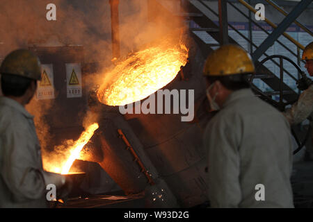 ------ Chinesische Arbeiter watch geschmolzenen Stahl in eine Form in einer Gießerei in Nantong City, East China Jiangsu Provinz, 13. November 2013. Ch Stockfoto