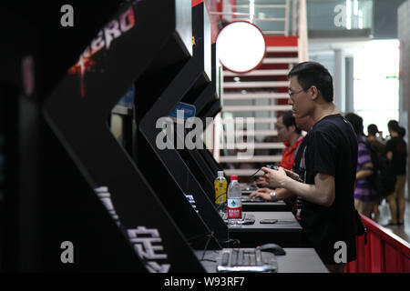 Besucher spielen elektronische Videospiele während des 11 China Digital Entertainment Expo und Konferenz, wie ChinaJoy 2013 in Shanghai, China, 25 J bekannt Stockfoto