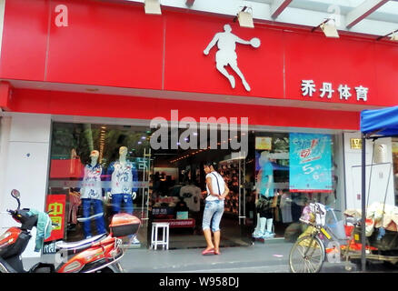 ---- Ein Kunde geht in ein Shop für Sportbekleidung von Qiaodan, die Chinesische Übersetzung von Jordanien, in Shanghai, China, 16. August 2011. Michael Jordan, t Stockfoto