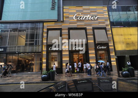 Kunden warten außerhalb eines Luxusmarke Cartier in Hongkong, China, 29. Mai 2012. Cartier hat zwei Klagen gegen zwei Peking comp eingereicht Stockfoto