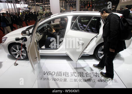---- Besucher betrachten ein Volvo V60 Plug-in Hybrid Auto am 14. Shanghai Internationalen Automobil- Ausstellung, die Auto Shanghai 2011 bekannt Stockfoto