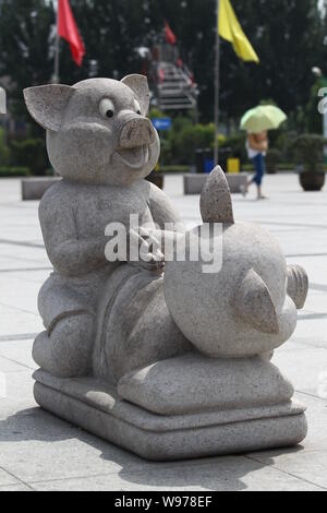 Eine steinerne Skulptur von zwei Schweine, die wie Paarung zu schauen auf dem Platz vor dem Wahrzeichen Bau angezeigt ist, die Zentrale Ebene Blessednes Stockfoto