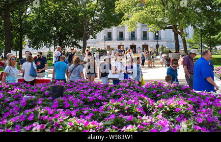 Farmers Market, Madison, WI USA. Aug 2018. Menschen zu Fuß auf den Markt durch die üppigen Blumengarten am State Capitol. Stockfoto