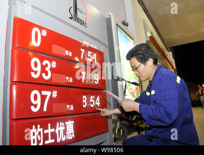 Ein chinesischer Arbeiter aktuelles Kraftstoffpreise vor 24.00 Uhr an einer Tankstelle von Sinopec in Shenzhen City, South China Hainan Provinz, den 6. April 2011. C Stockfoto