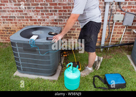 Air Conditioenr Wartungstechniker hinzufügen kühlend Stockfoto