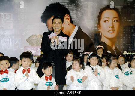 Hong Kong Sänger und Schauspieler Andy Lau stellt mit Kindern während der Premiere des Films, was Frauen wollen, in Hongkong, China, 13. Februar 2011. Stockfoto