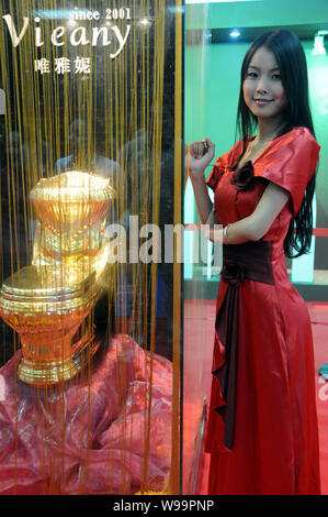 Ein Modell stellt das vom Gold wc während des 11 World Toilet Summit und Expo in Haikou, South China Hainan Provinz, 22. November 2011. Die glänzenden s Stockfoto