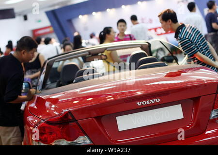 ------ Chinesischer Besucher Blick an einem Volvo C70 bei der Auto Show in Beijing City, South China Hainan Provinz, den 5. September 2008. China Geely auf Mon Stockfoto