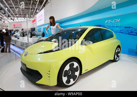 Ein Modell stellt neben einem Toyota FT-CH Kompakte Hybrid Concept auf der 11. Internationalen Automobil Ausstellung, wie Auto China 2010 bekannt, in Beij Stockfoto