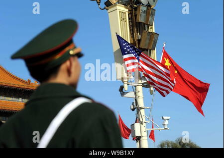 ---- Einen Chinesischen paramilitärischen Polizist wacht vor eine Laterne auf dem Chinesischen und US-amerikanischen nationalen Flaggen hingen den Besuch von willkommen sind Stockfoto