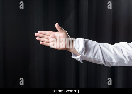 Des Menschen Hand auf einem dunklen Hintergrund Stockfoto