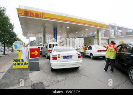 ------ Autos auf Warteschlange an einer Tankstelle von Shell in Peking, China, 18. Juni 2009 betankt werden. Royal Dutch Shell plc verkündet Montag (12. Oktober Stockfoto