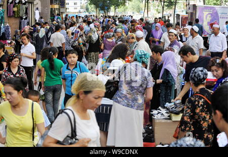 Lokalen chinesischen Uigurischen Bürger vorbei zur Straße Anbieter auf einer Straße in Urumqi im Nordwesten Chinas Autonome Region Xinjiang Uygur, 12. Juli 2009. L Stockfoto