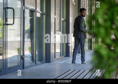 Selektiver Fokus der Entlassenen afrikanischen amerikanischen Geschäftsmann zurück Warum holding Karton Stockfoto