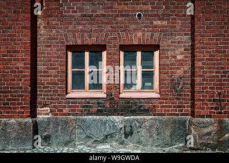 Zwei Fenster auf eine Mauer von einem alten Industriegebäude in Helsinki, Finnland. Stockfoto