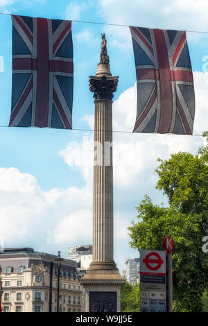 LONDON, Großbritannien - 21. JULI 2018: Nelson's Column zwischen zwei Union Jack Flaggen auf dem Trafalgar Square Stockfoto